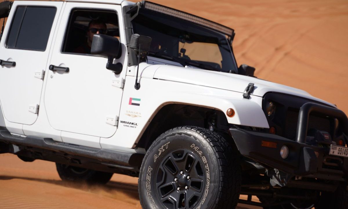 4x4 off-road vehicle on sand dunes with aired-down tires