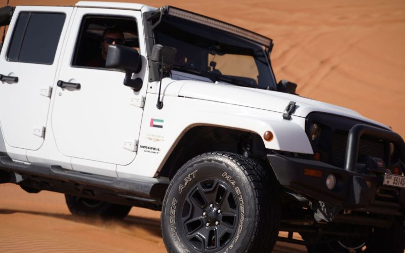 4x4 off-road vehicle on sand dunes with aired-down tires