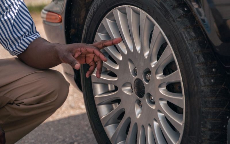 Inspecting a car tire by hand for overinflation