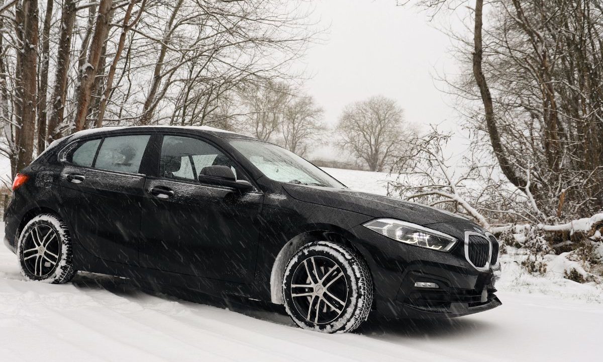 Car driving on a snow-covered road in winter