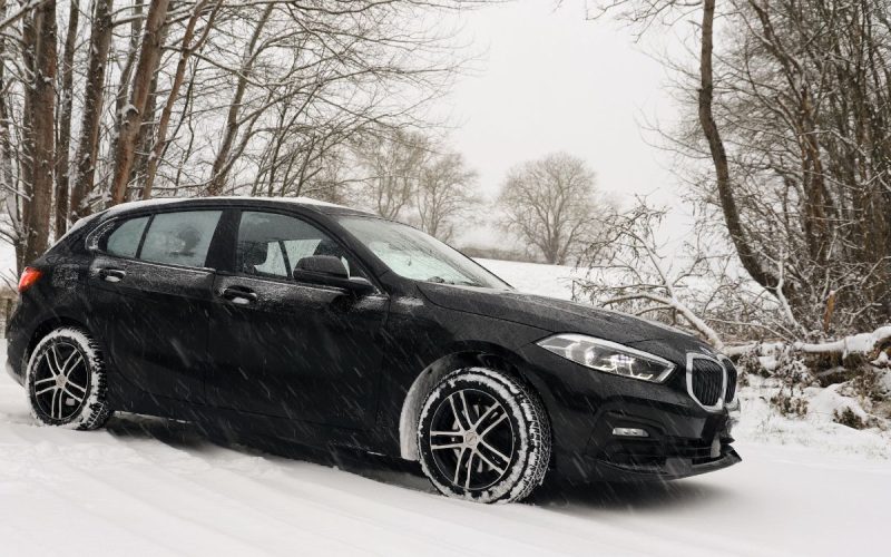 Car driving on a snow-covered road in winter